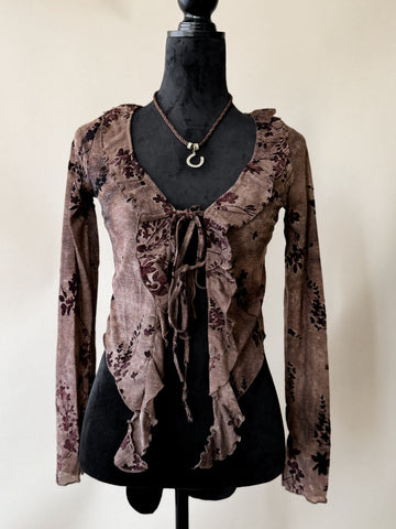 Brown floral blouse on a mannequin against a plain background