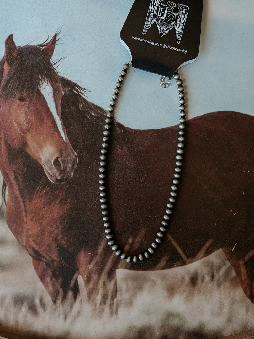 Western style silver beaded necklace on background with brown horse, boho cowgirl jewelry