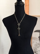 Thunderbird pendant chain necklace displayed on wooden slab with serape fabric underneath - The Wild J