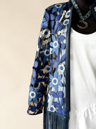 Sheer blue floral embroidered fringe jacket over white dress, western boho style