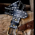 Thunderbird pendant chain necklace displayed on wooden slab with serape fabric underneath - The Wild J