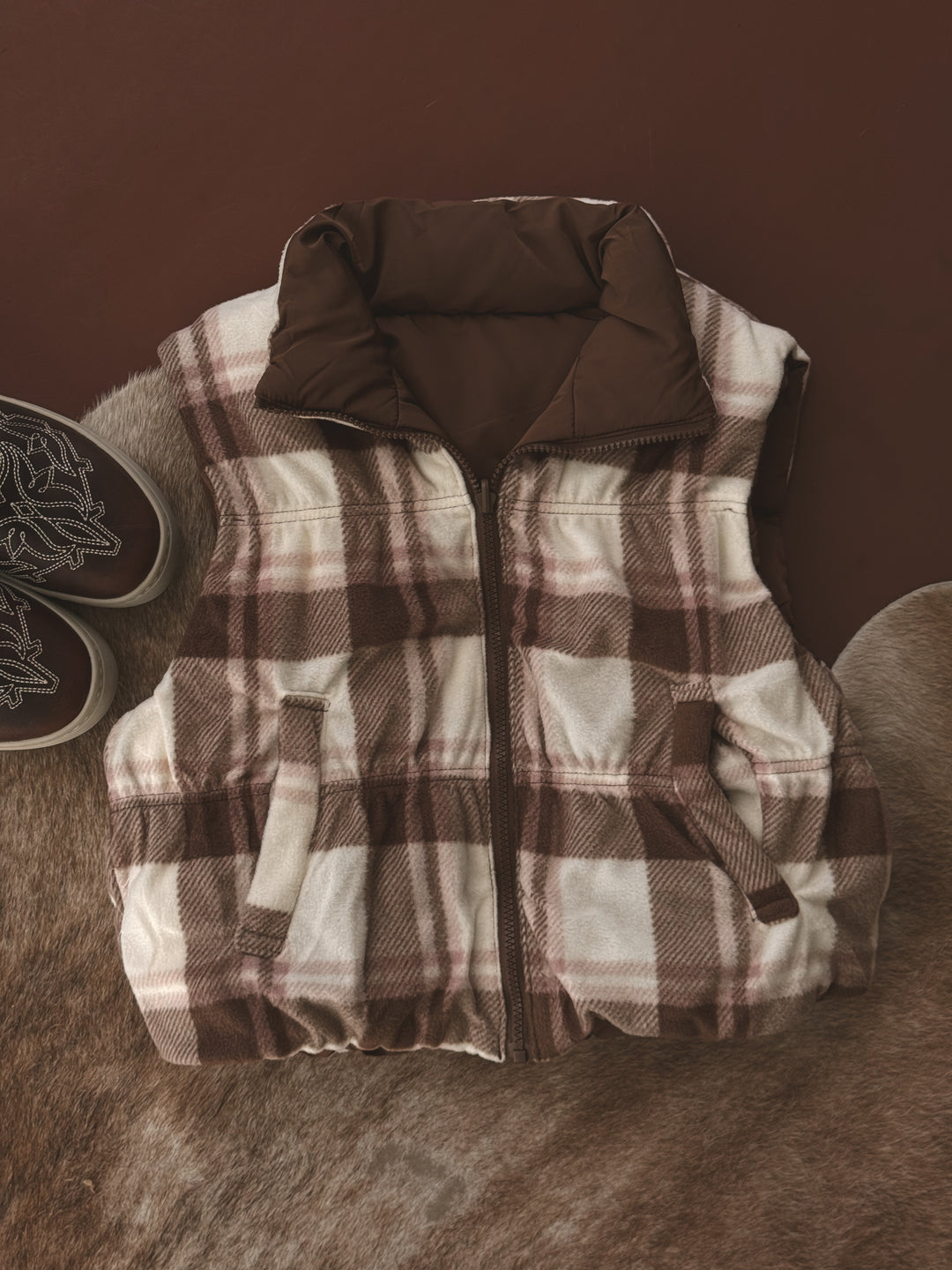 Plaid vest on a brown textured surface