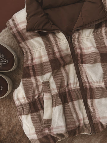 Plaid jacket with brown and white pattern on a textured surface