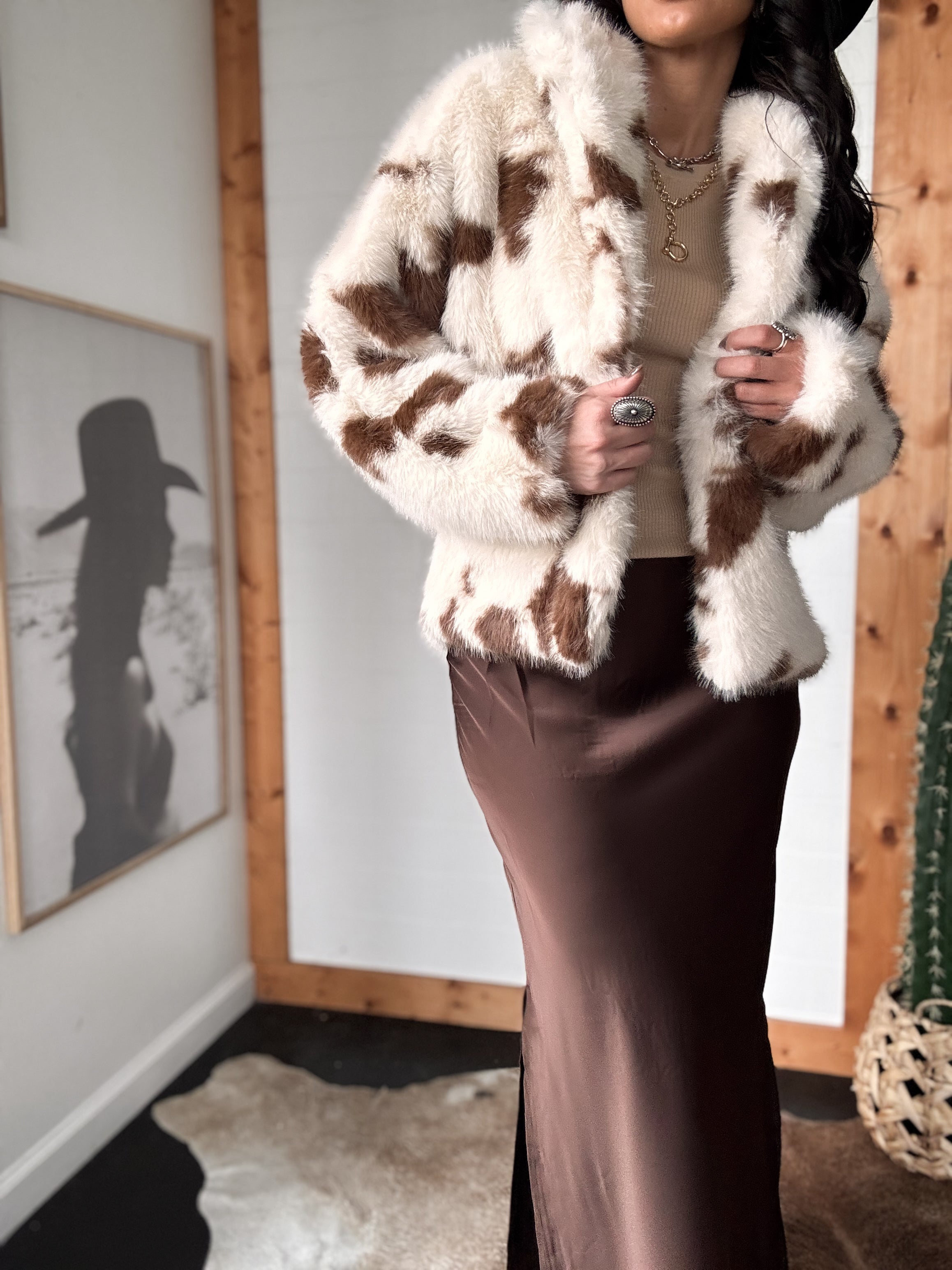 brown western maxi skirt with fluid drape, styled with cow print fur coat