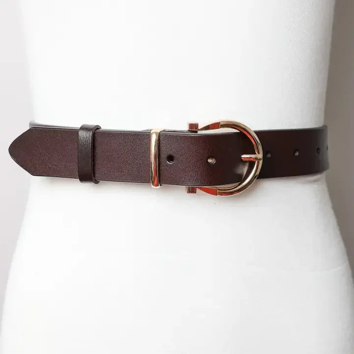 Brown western leather belt with gold buckle on white mannequin, cowgirl accessory