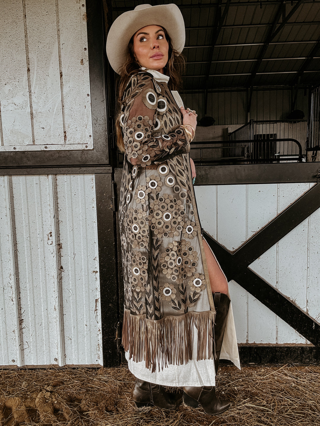 black and gold cardigan with fringe and floral appliqué