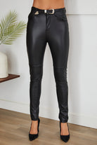 High-waisted black faux leather pants with belt, styled with heels, western chic look