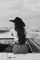 Thunderbird pendant chain necklace displayed on wooden slab with serape fabric underneath - The Wild J