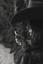 Thunderbird pendant chain necklace displayed on wooden slab with serape fabric underneath - The Wild J