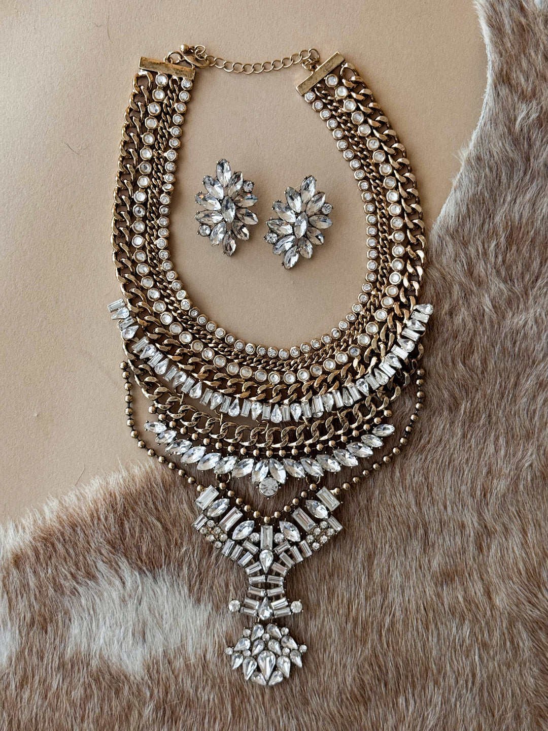 Antique gold-tone layered chain necklace with crystal accents and matching crystal statement stud earrings