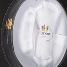 Close-up of the interior satin lining of a western cowboy hat with gold crest and USA marking