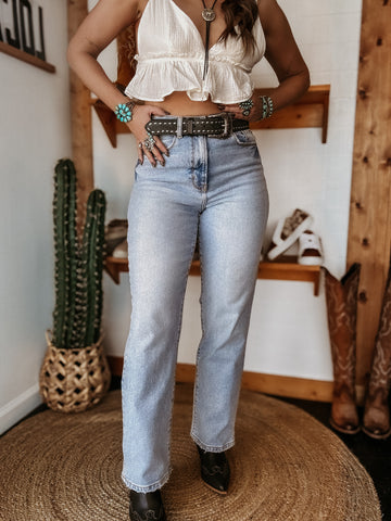 Front view of Super High-Rise Western Dad Jeans in light wash denim styled with boots and concho belt.
