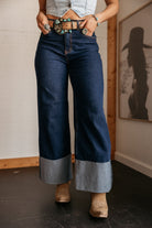 High rise western cuff jeans with wide legs, statement belt, and cowgirl boots