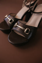 Black block heel sandals with gold horsebit detail, western boho accessory style