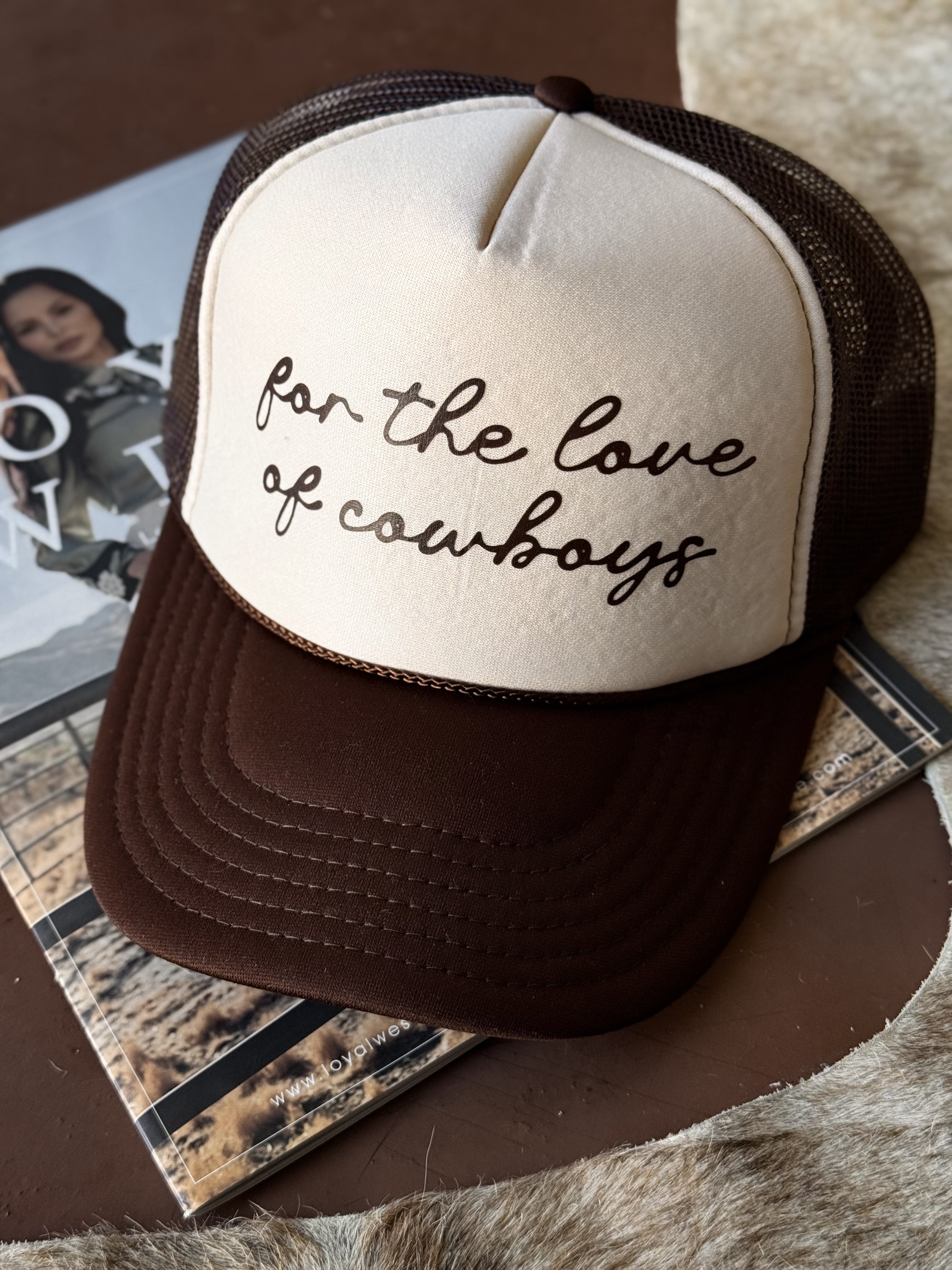 Brown and cream trucker hat with 'for the love of cowboys' western script on front.