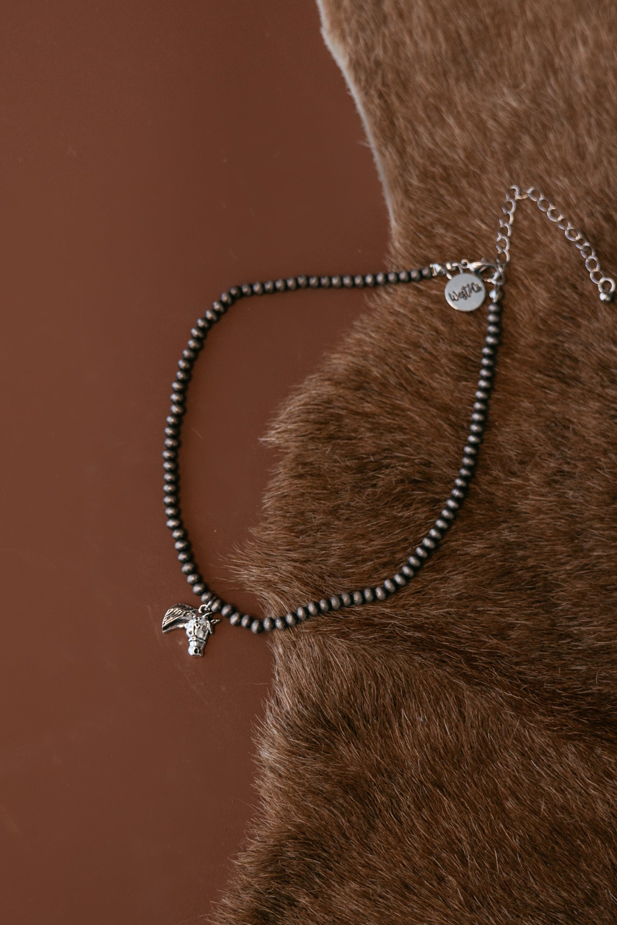 Pearled bead necklace with silver horse head charm
