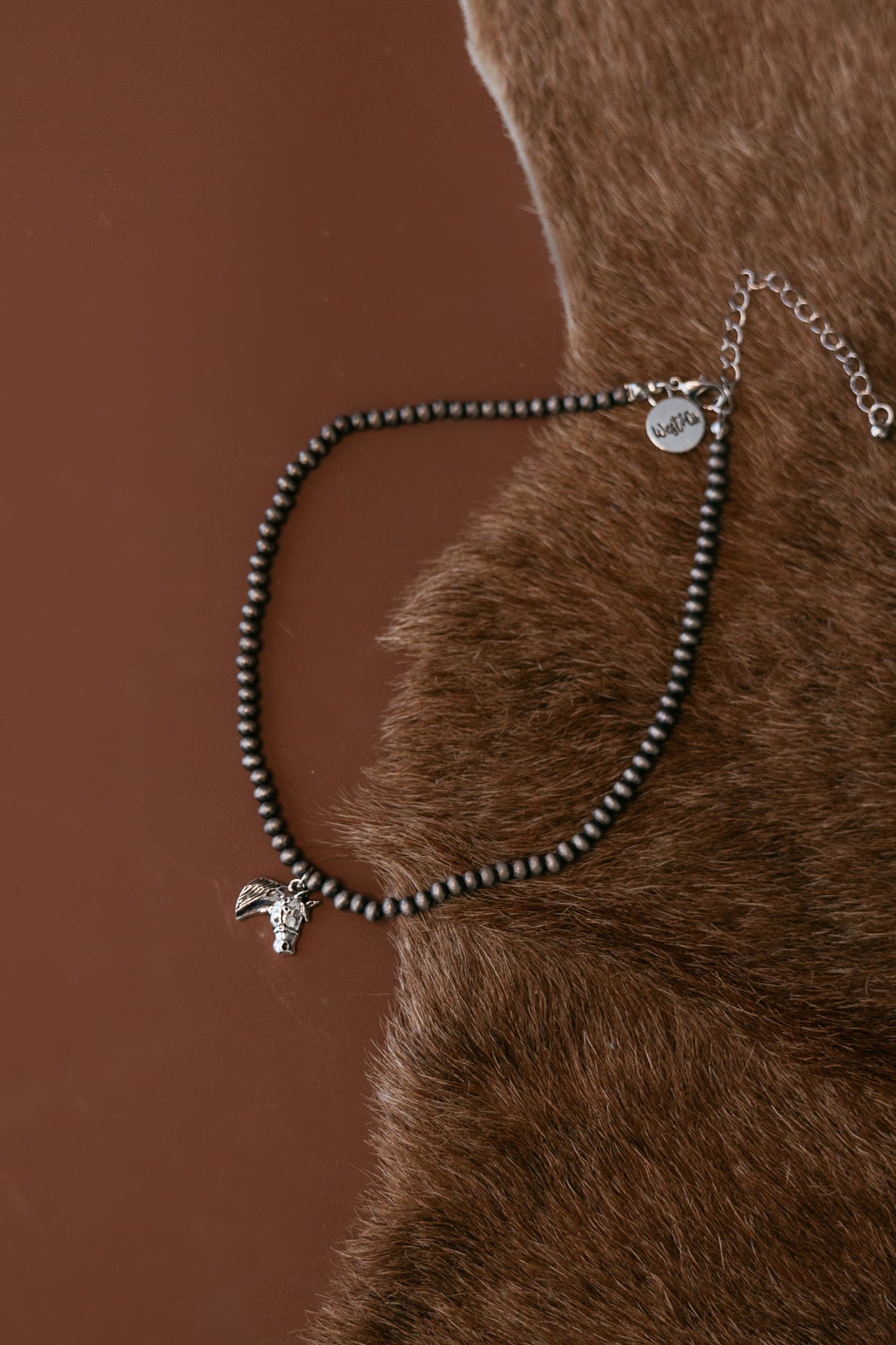 Pearled bead necklace with silver horse head charm