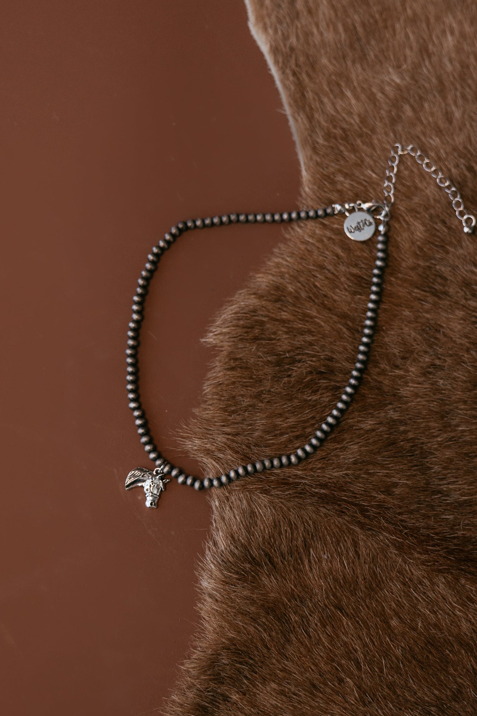 Pearled bead necklace with silver horse head charm