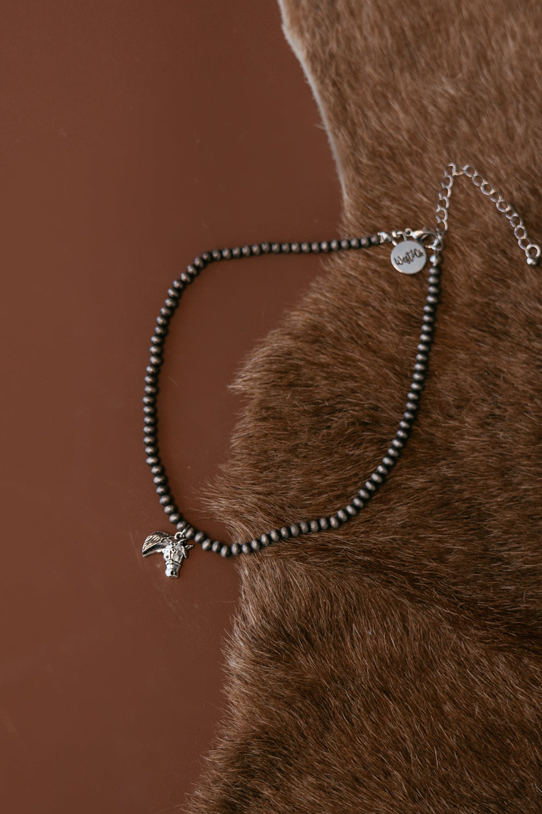 Pearled bead necklace with silver horse head charm