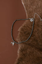 Pearled bead necklace with silver horse head charm