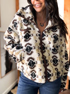 Person wearing a patterned fleece jacket indoors