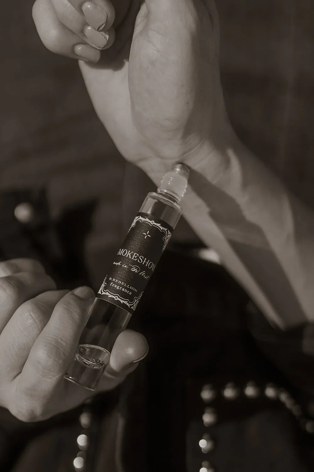 Thunderbird pendant chain necklace displayed on wooden slab with serape fabric underneath - The Wild J