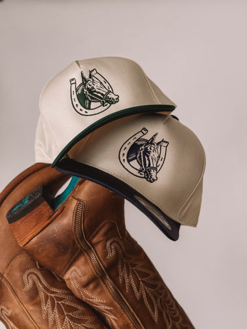 Cream women’s trucker hat with embroidered horse-head logo